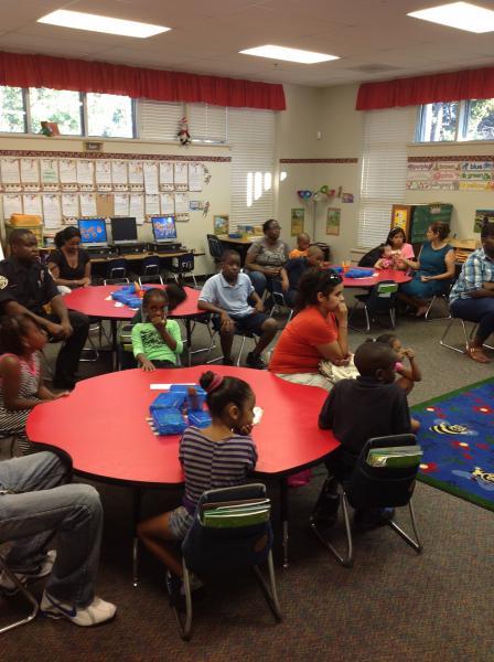 Parents and students listening to the presentation by their teacher. 